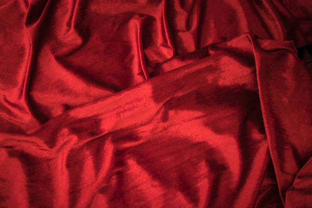 istock Fold soft waved red velour fabric textured background. 1033168238