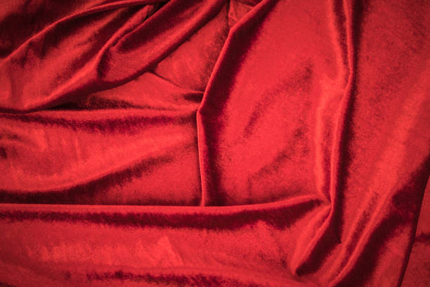 istock Fold soft waved red velour fabric textured background. 1033168248
