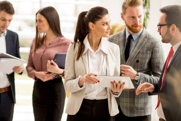 istock Smiling business team working with digital tablet in office 1033168318
