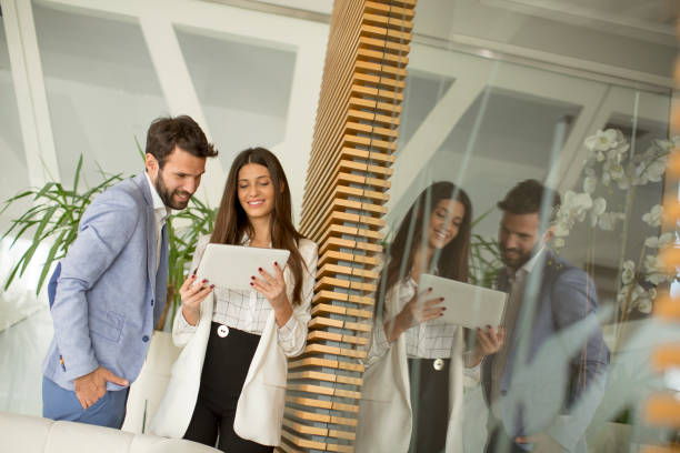 istock Young business people with digital tablet in the office 1033168762