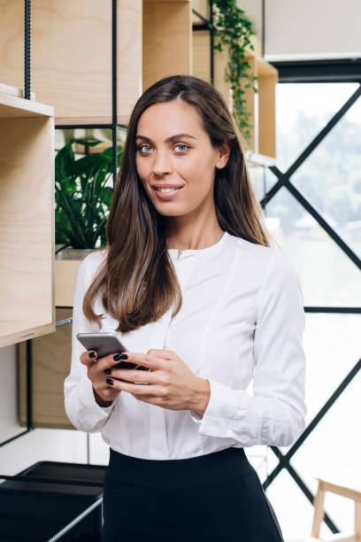 istock Young businesswoman using mobile phone in office 1033172420