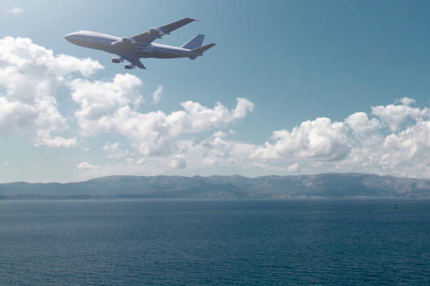 istock airplane flying over the sea 1033187166