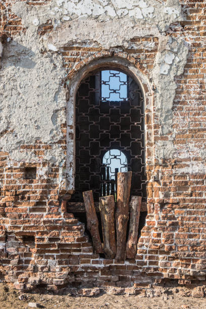 istock wall with a window of an old destroyed church 1033189738