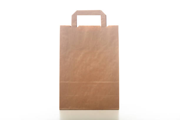 Brown paper shopping bag isolated on white background