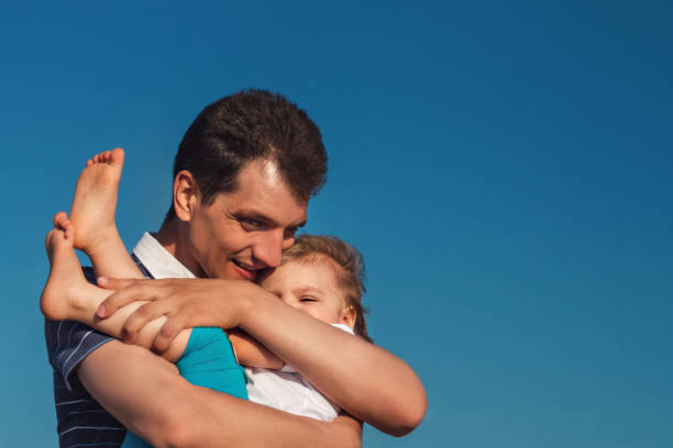 istock Man father holds his child in arms 1033194550