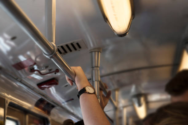 istock hand holding onto the bar in an old subway during rush hour 1033202954