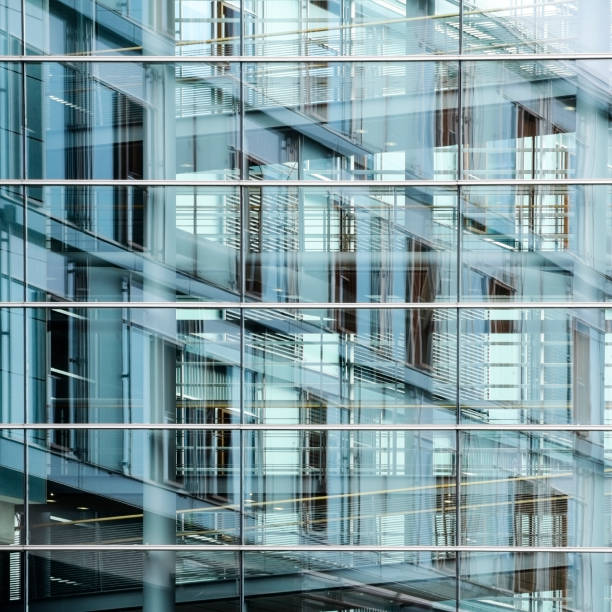 istock modern glass facade with reflection, background texture for international business in a big city 1033205232