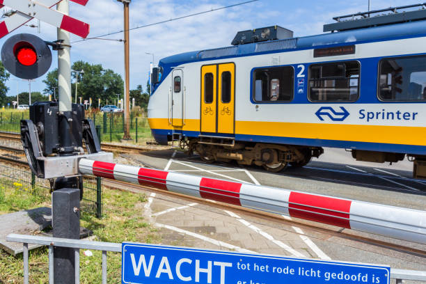dutch electric train moving over crossing Hoek van Holland, the Netherlands - July 6, 2016: Dutch electric train going through crossing tasrail stock pictures, royalty-free photos & images