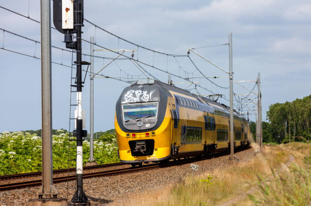 Dutch intercity electric passenger train riding through the countryside Flevoland, the Netherlands - June 19, 2016: Dutch intercity electric passenger train riding through the countryside tasrail stock pictures, royalty-free photos & images