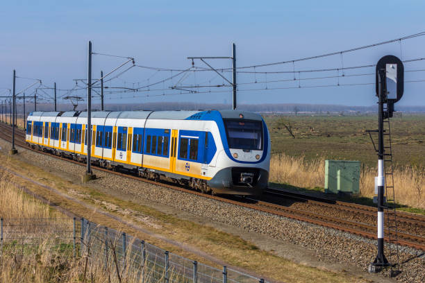 Dutch snel train traveling through countryside Flevoland, the Netherlands - March 26, 2016: Dutch snel train traveling through countryside. tasrail stock pictures, royalty-free photos & images