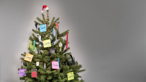 istock Christmas tree decorated with decorations of business items and keywords on post-it notes 1033209734