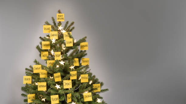 istock Christmas tree decorated with 25 yellow post-it notes with business keywords and wishes 1033211038