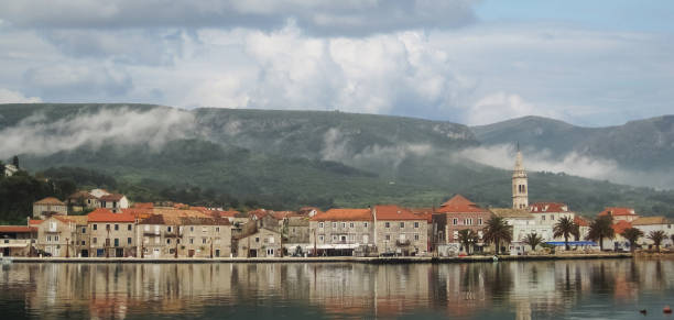 Town Jelsa Beautifull Panoramic view on old town Jelsa on cloudy day and hills with fog,reflection jelsa stock pictures, royalty-free photos & images