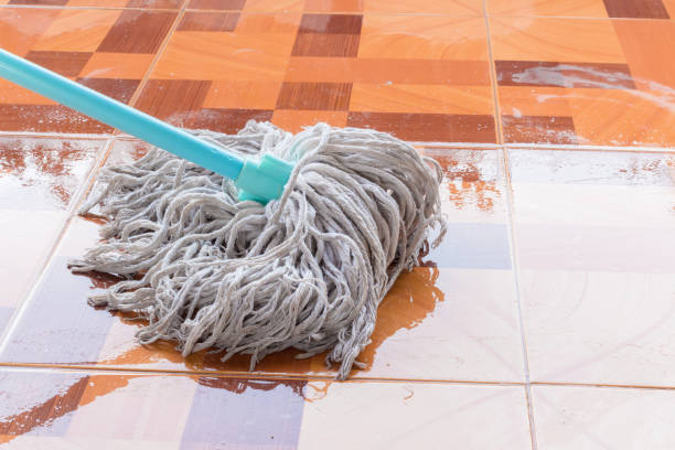 Mop the tile floor in home stock photo