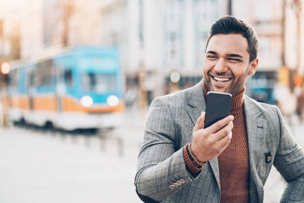 istock Smiling businessman with cell phone 1033226422