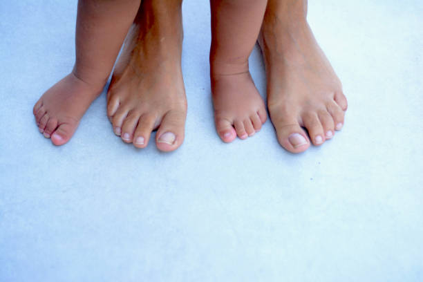 istock Baby Feet with Mother 1033236716