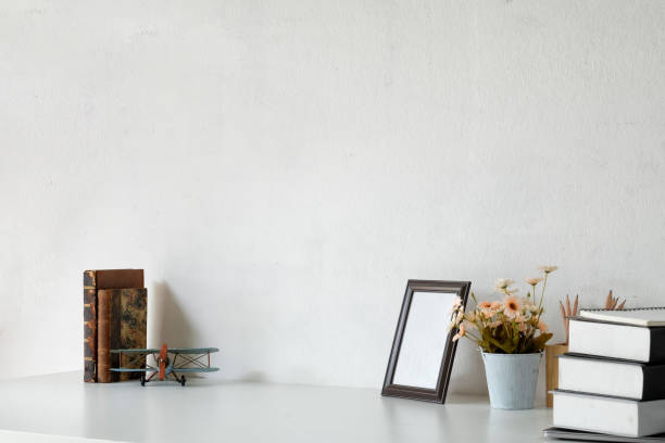 istock Student workspace with books, mockup poster and vintage toy. 1033240438