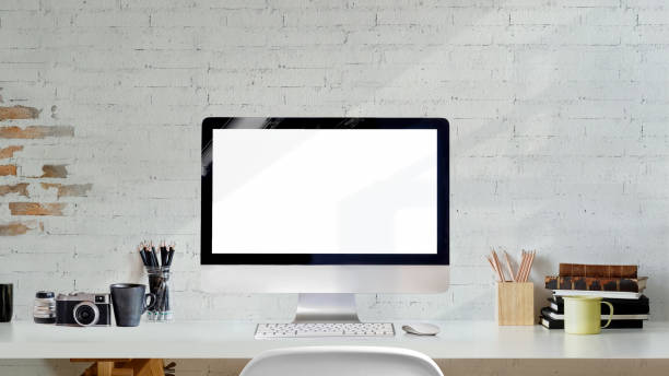 istock Loft creative photographer workspace with blank screen desktop computer on white wood desk. 1033240448