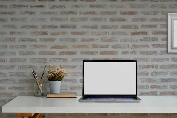 istock Loft workspace with mockup blank screen laptop and supplies. 1033240874