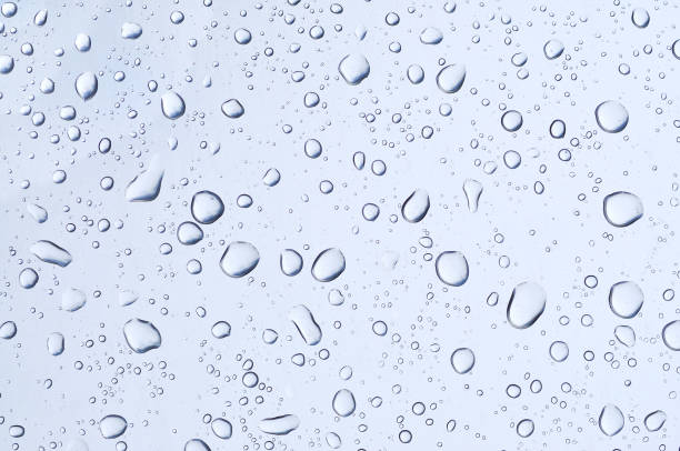 istock Water drops on glass mirror background 1033250408