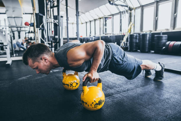 istock Exercising with kettle bell in the gym 1033257438