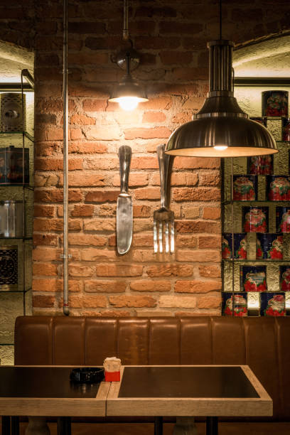 istock Decoratd detail of restaurant interior, ceiling lamp table and brick wall 1033271610