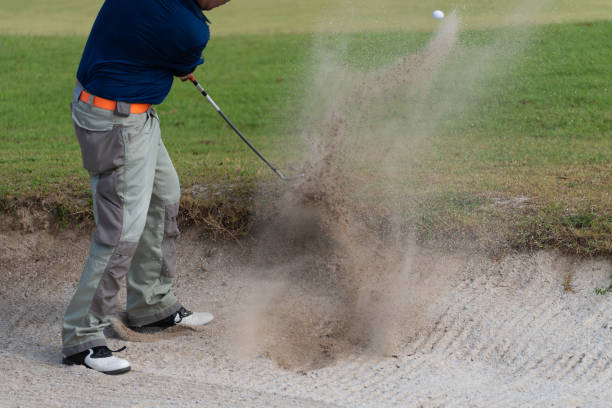 istock Thai young man golf player in action swing in sand pit during practice before golf tournament at golf course 1033271716