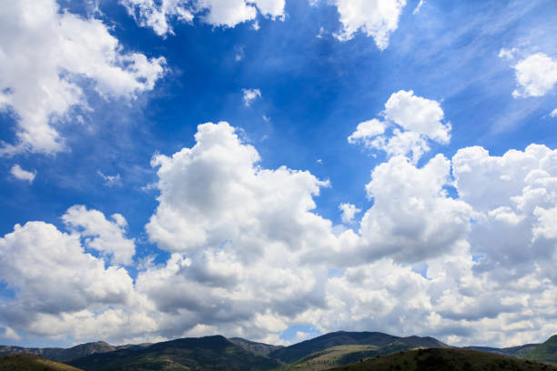 Scenic rural background with blue sky and white fluffy clouds