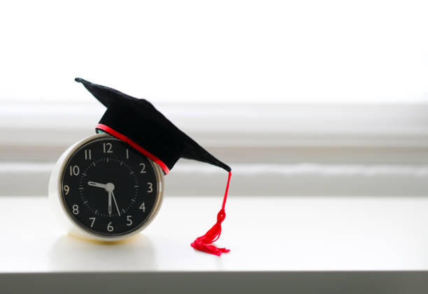 istock Mortarboard on an alarm clock isolated in white background 1033278818