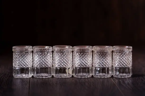 Decorative cut glass crystal glasses on brown background