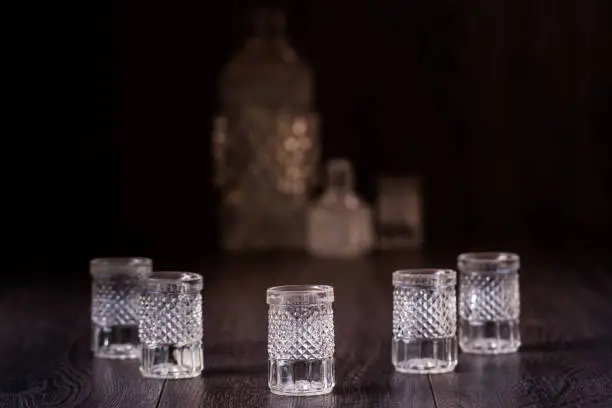 Decorative cut glass crystal glasses on brown background