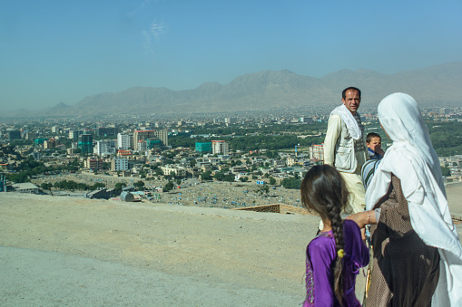 Photo of pedestrians walking on foot with their children in Kabul, Afghanistan