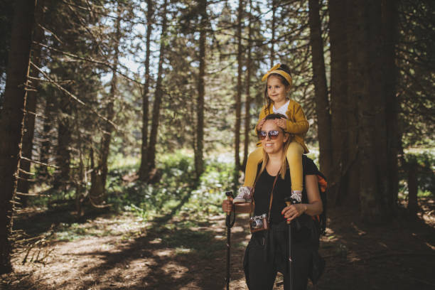 istock Mother carrying her daughter through a mountain forest 1033295236