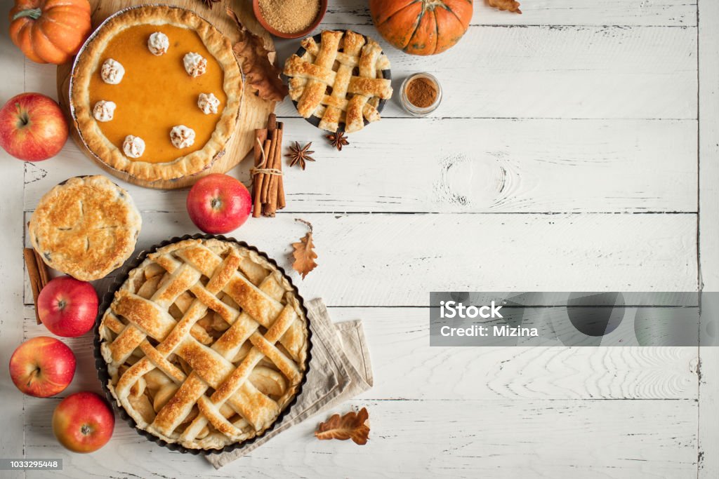Thanksgiving pumpkin and apple various pies Thanksgiving pumpkin and apple various pies on white, top view, copy space. Fall traditional homemade apple and pumpkin pie for autumn holiday. Thanksgiving - Holiday Stock Photo