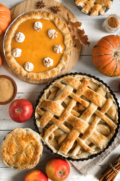 Thanksgiving pumpkin and apple various pies Thanksgiving pumpkin and apple various pies, top view, copy space. Fall traditional homemade apple and pumpkin pie for autumn holiday. dessert pie stock pictures, royalty-free photos & images