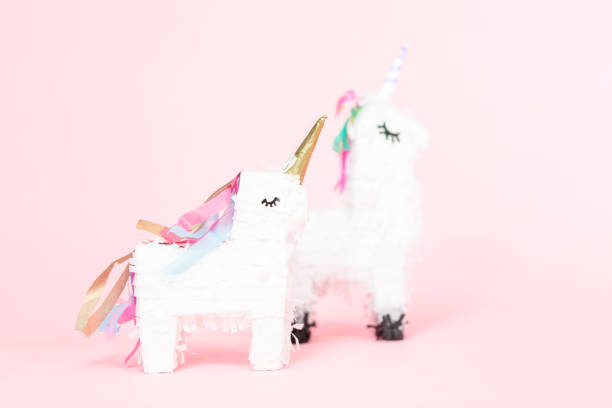 istock White unicorn pinata on a pink background. 1033298540