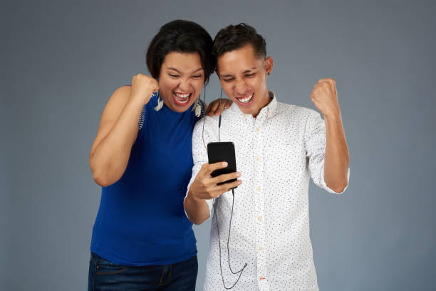 istock Happy young couple with smartphone 1033299070