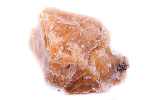 istock Macro mineral stone yellow calcite on a white background close up 1033299256