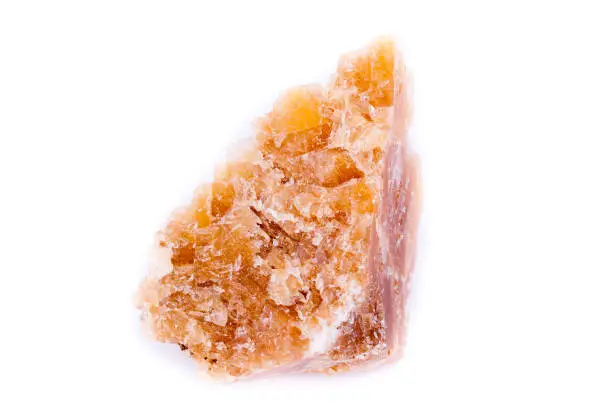 Macro mineral stone yellow calcite on a white background close up