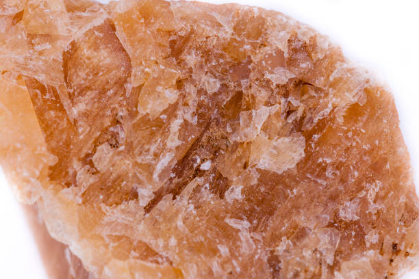 istock Macro mineral stone yellow calcite on a white background close up 1033299312
