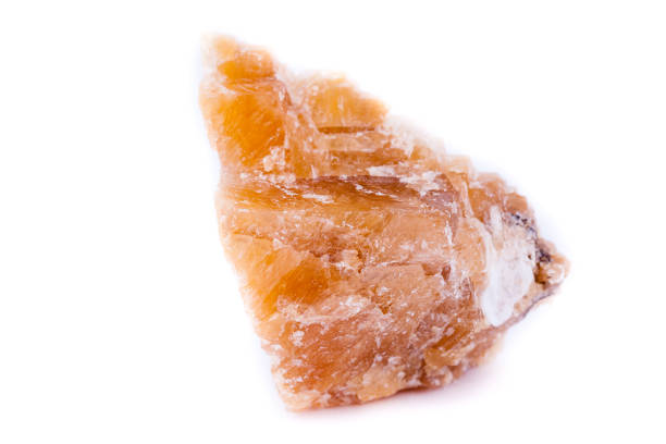 istock Macro mineral stone yellow calcite on a white background close up 1033299374