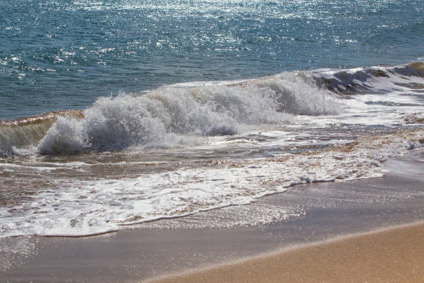 istock Sea waves splash on the sea shore 1033306812