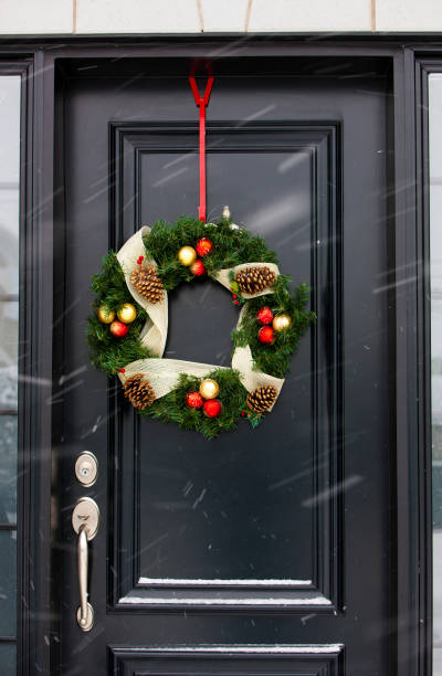 istock Christmas wreath on black door. 1033307384