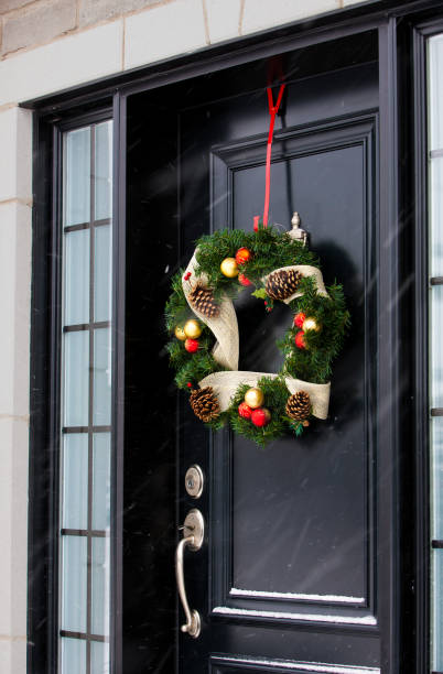 istock Christmas wreath on black door. 1033307424