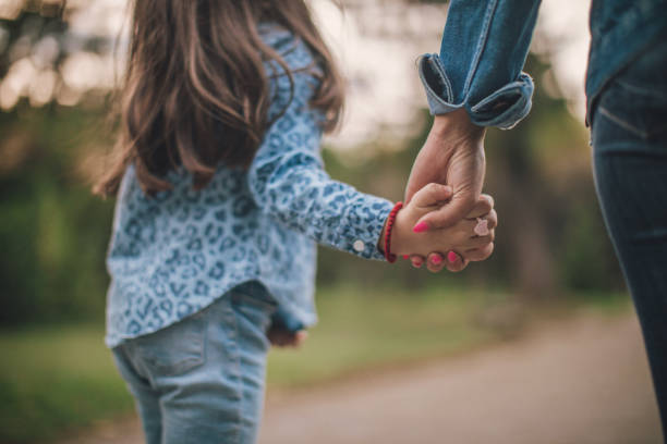 istock Mother and daughter holding hands 1033310056