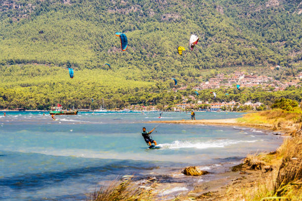 Akyaka Village in Turkey Akyaka, Turkey - August 14, 2018 : People are riding kitesurfing in Gokova Gulf of Turkey. kekova stock pictures, royalty-free photos & images