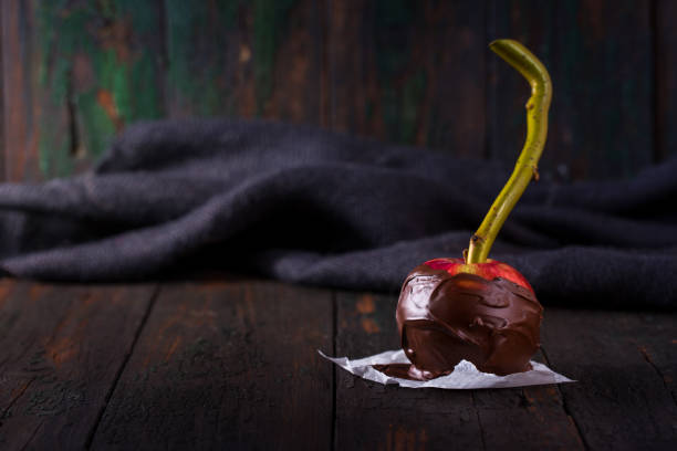 One red apple in chocolate stock photo