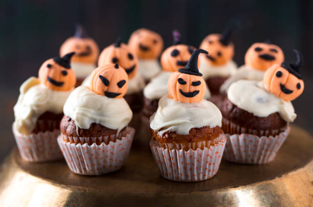 istock Cupcakes with orange pumpkins 1033318884