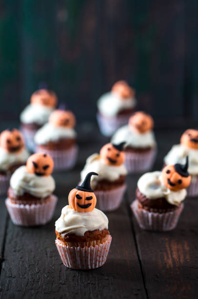 istock Cupcakes with orange pumpkins 1033318890
