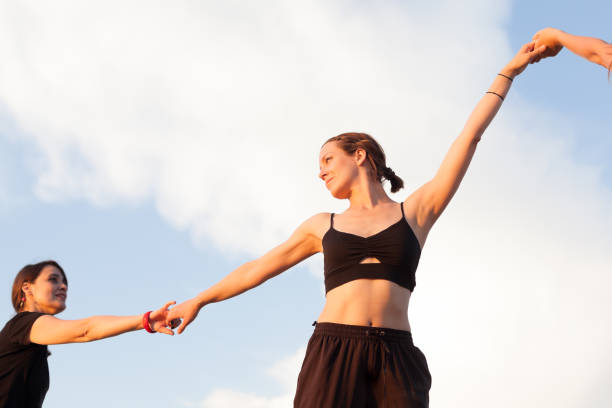 istock young women holding hands 1033327298